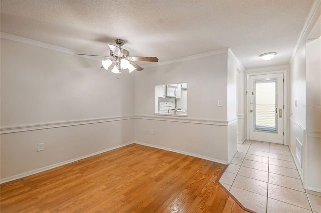 entrance foyer with crown molding, ceiling fan, light hardwood / wood-style floors, and a textured ceiling