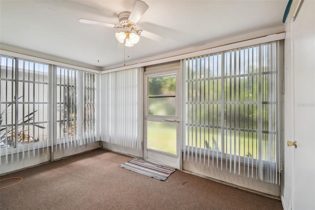 unfurnished sunroom with ceiling fan