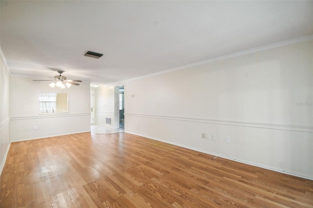 spare room featuring crown molding, ceiling fan, and light hardwood / wood-style flooring