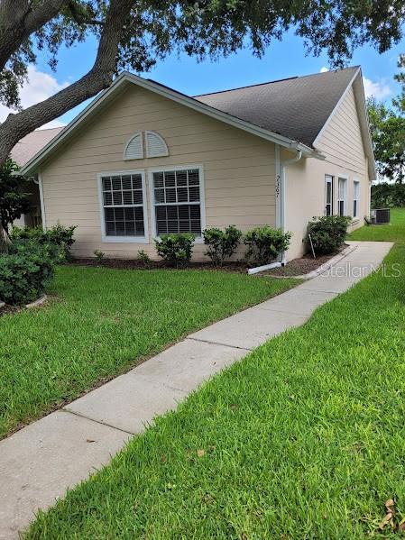 view of property exterior featuring a yard and cooling unit