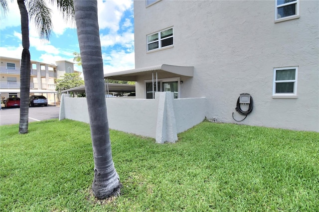 view of side of property with a lawn