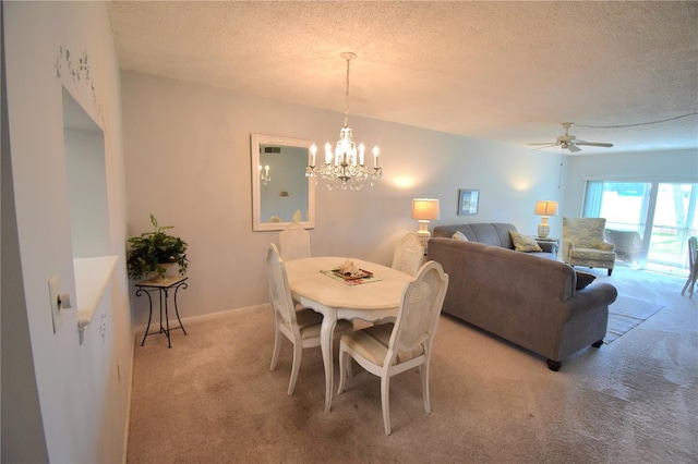 dining area with light carpet, a notable chandelier, and a textured ceiling