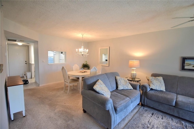 carpeted living room with a textured ceiling and an inviting chandelier