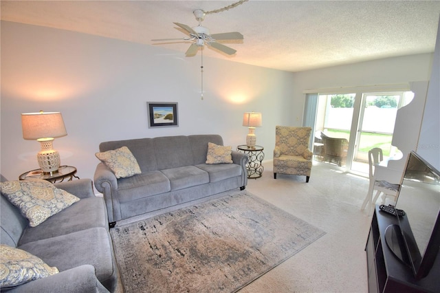 living room featuring a textured ceiling, ceiling fan, and carpet floors