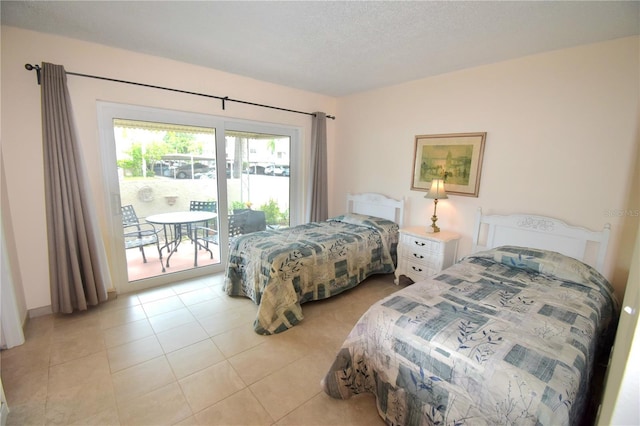 bedroom with light tile patterned floors, access to outside, and a textured ceiling