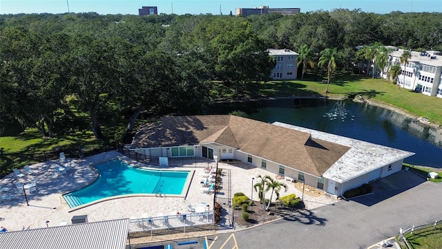 view of swimming pool with a water view and a patio