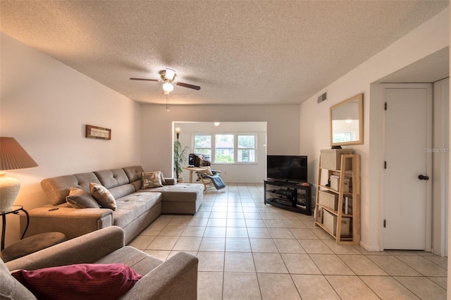 tiled living room featuring ceiling fan and a textured ceiling