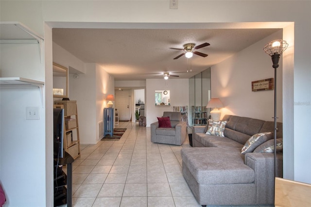 living room featuring ceiling fan, a textured ceiling, and light tile patterned flooring