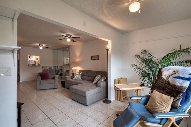 tiled living room featuring ceiling fan and a textured ceiling