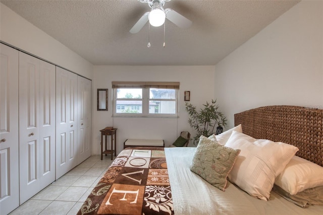 tiled bedroom featuring ceiling fan and a textured ceiling