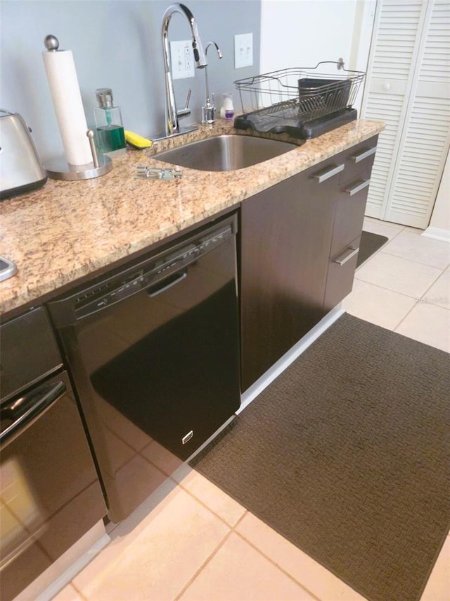 kitchen featuring sink, dishwasher, light stone countertops, and light tile patterned floors