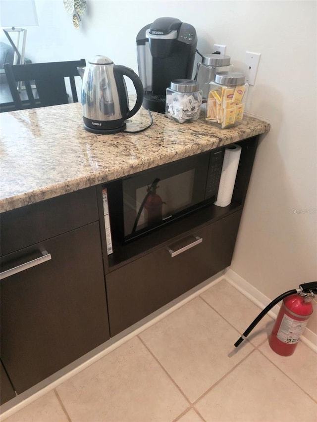 room details featuring tile patterned floors and light stone countertops