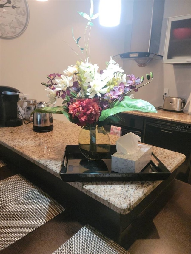 interior details featuring black dishwasher and wall chimney range hood