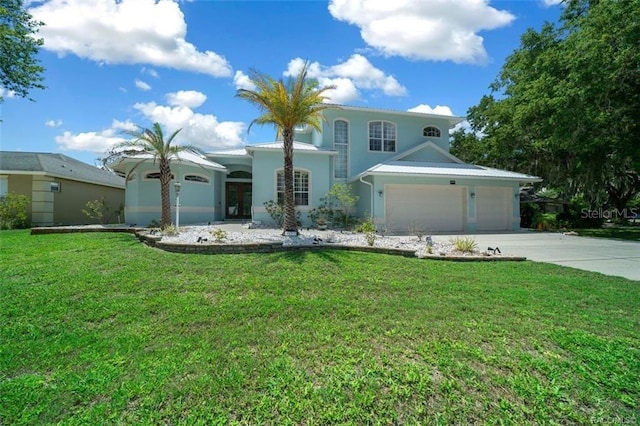 mediterranean / spanish house with a garage and a front lawn