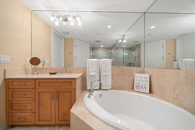 bathroom featuring a bath, a stall shower, vanity, and visible vents