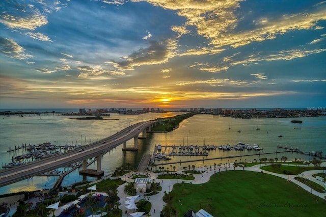 aerial view at dusk featuring a water view