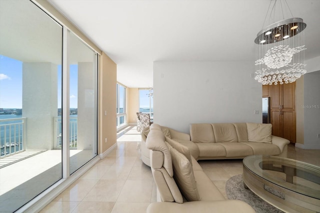 living area featuring expansive windows, a water view, a notable chandelier, and light tile patterned flooring