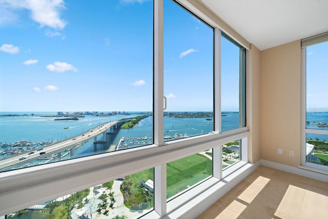 unfurnished sunroom featuring a water view