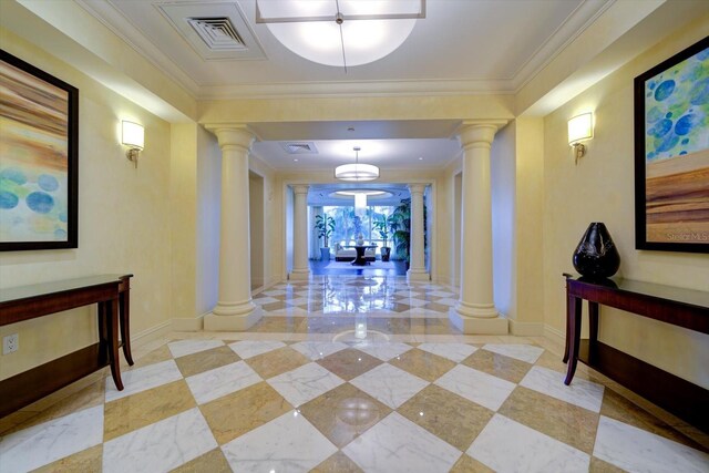 hallway with ornamental molding, ornate columns, and light tile patterned flooring