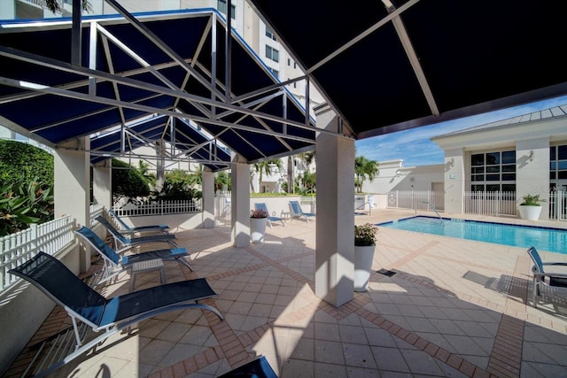 view of patio / terrace featuring fence and a community pool