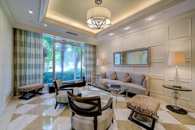 living room with visible vents, a raised ceiling, crown molding, a decorative wall, and recessed lighting