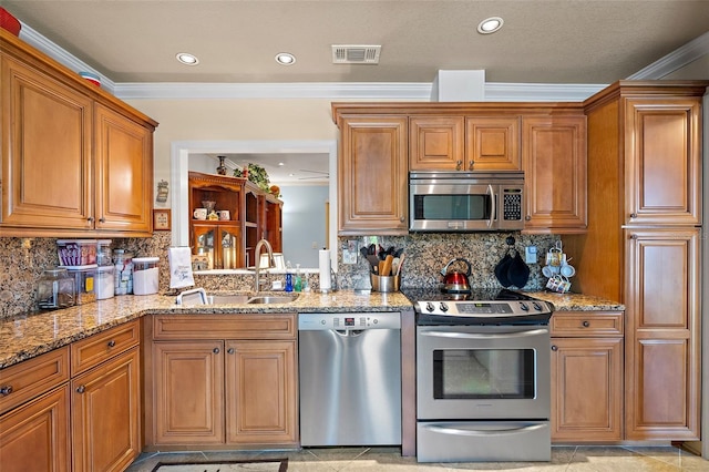 kitchen with backsplash, sink, ornamental molding, and stainless steel appliances