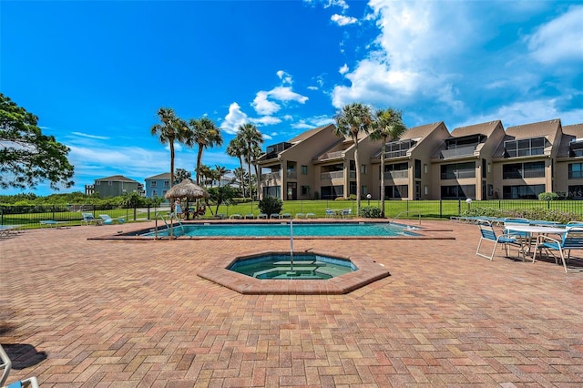 view of pool featuring a yard, a patio, and a hot tub