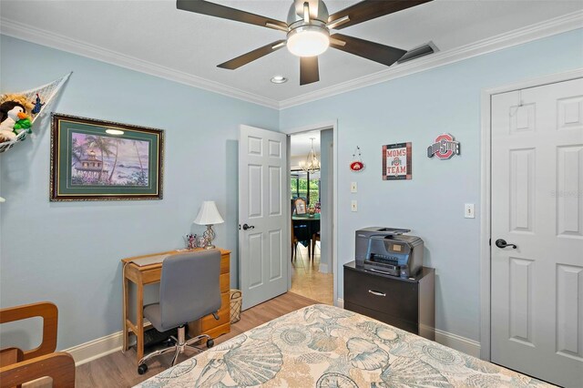 bedroom with ceiling fan with notable chandelier, light hardwood / wood-style floors, and crown molding