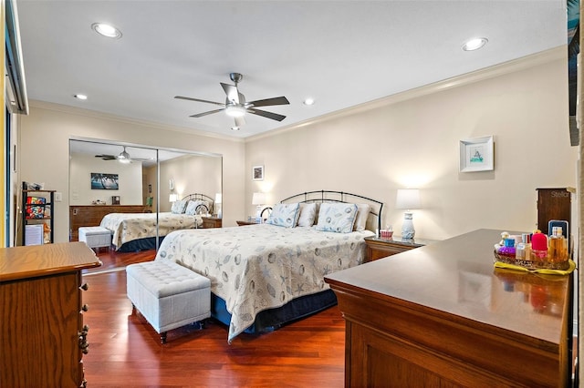 bedroom with dark hardwood / wood-style flooring, ceiling fan, a closet, and crown molding