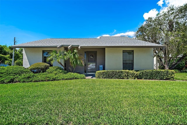 single story home with a front lawn