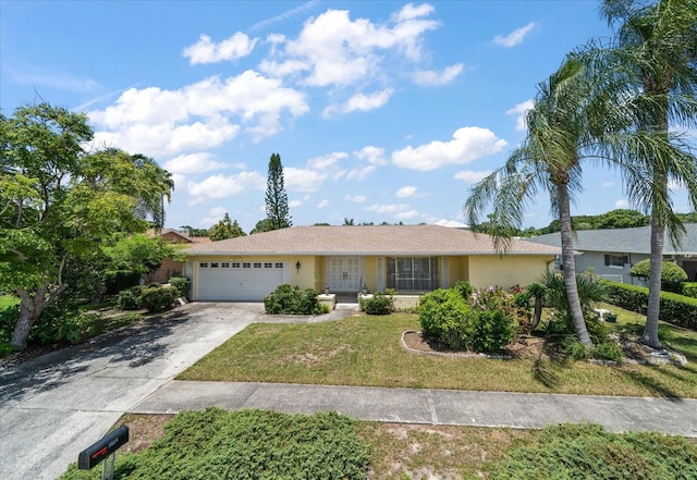 single story home featuring a front yard and a garage