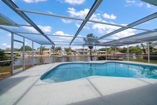 view of pool with glass enclosure and a water view