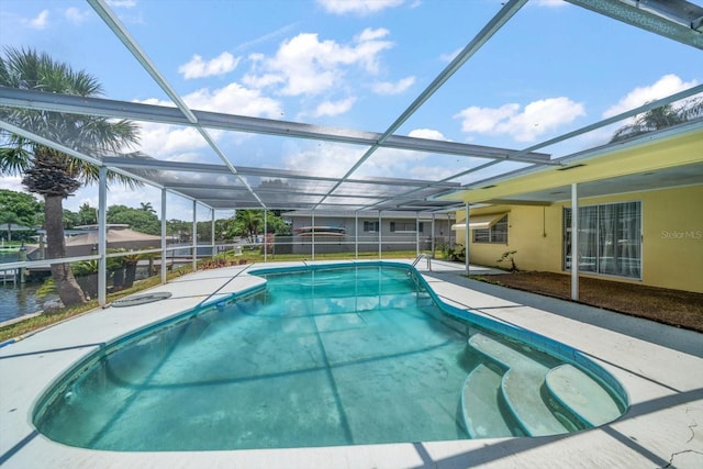 view of pool with glass enclosure