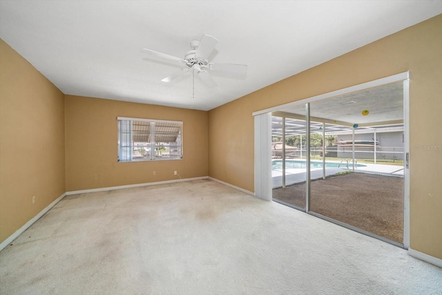 empty room with ceiling fan and light carpet