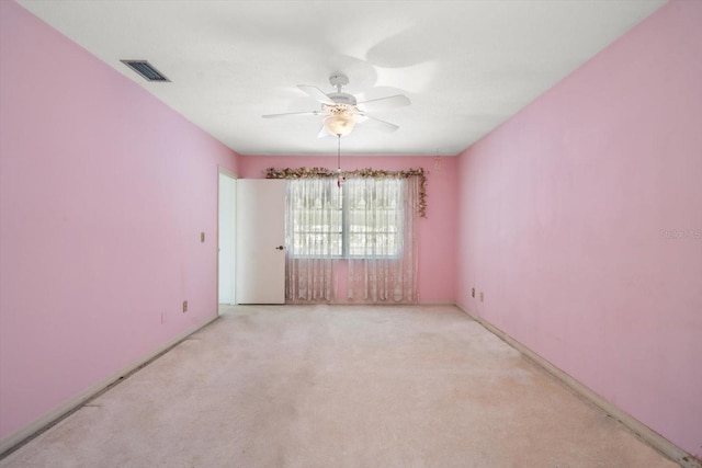 empty room featuring light carpet and ceiling fan