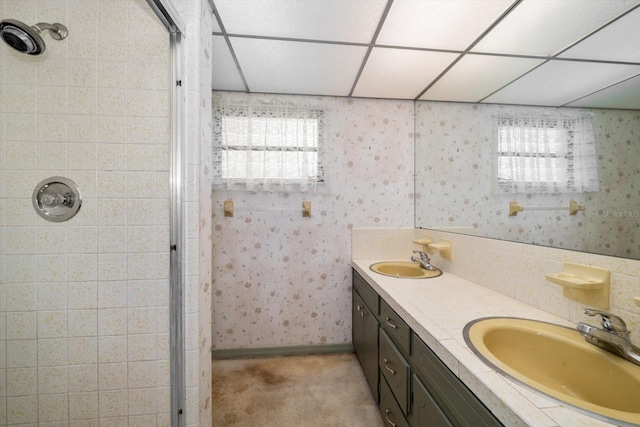 bathroom featuring a shower, a drop ceiling, and plenty of natural light