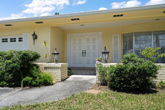 view of exterior entry with a porch