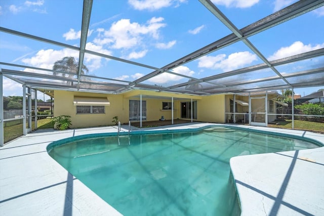 view of pool with glass enclosure