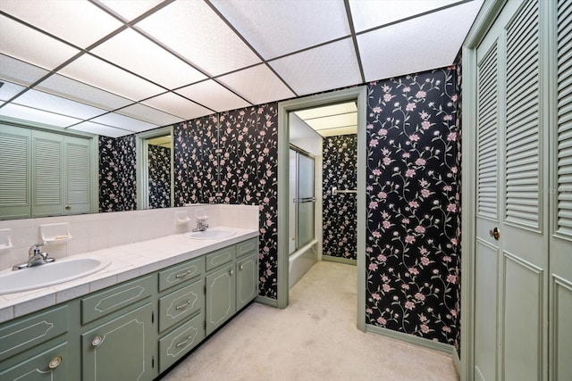 bathroom featuring a paneled ceiling and vanity