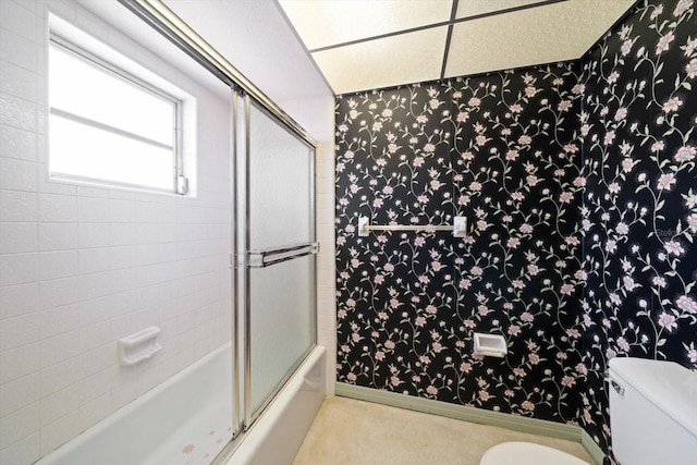 bathroom with enclosed tub / shower combo and toilet