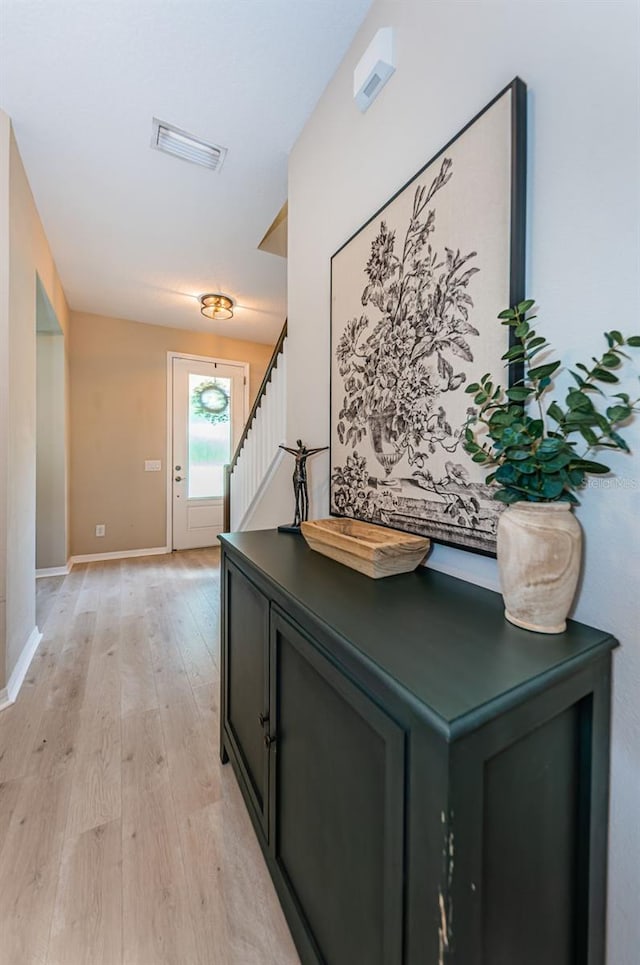 hall with light hardwood / wood-style floors