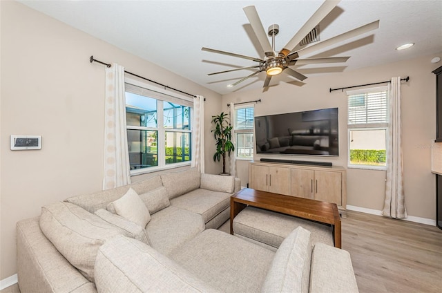 living room featuring light hardwood / wood-style floors, ceiling fan, and lofted ceiling