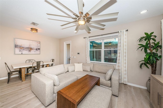 living room with ceiling fan and light hardwood / wood-style floors