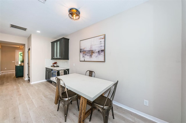 dining space with light hardwood / wood-style flooring