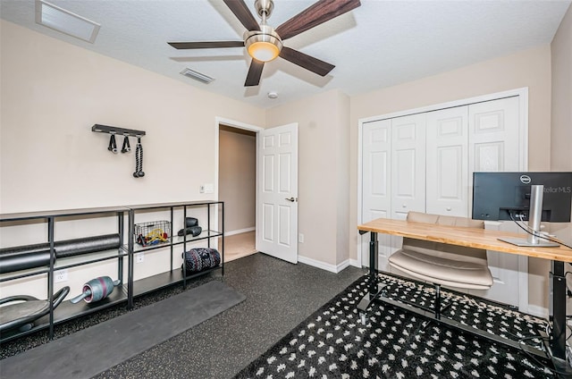 home office with ceiling fan and a textured ceiling