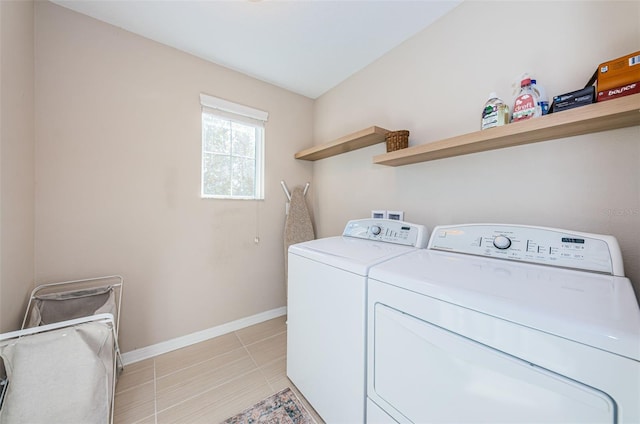 washroom featuring washer and clothes dryer and light tile patterned floors