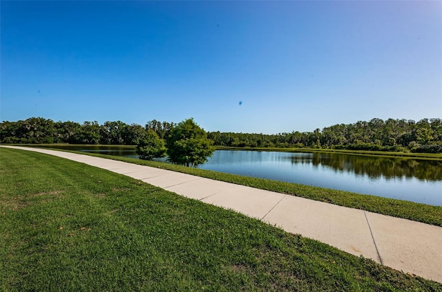 view of community with a lawn and a water view