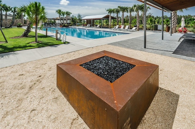 view of pool featuring a fire pit and a patio area