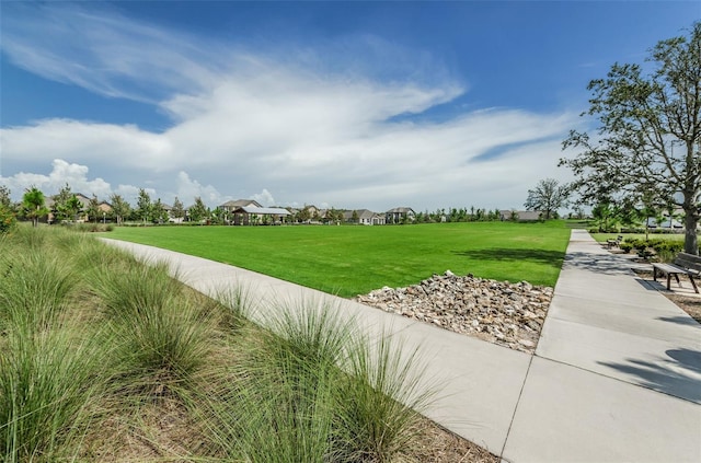 view of property's community featuring a yard