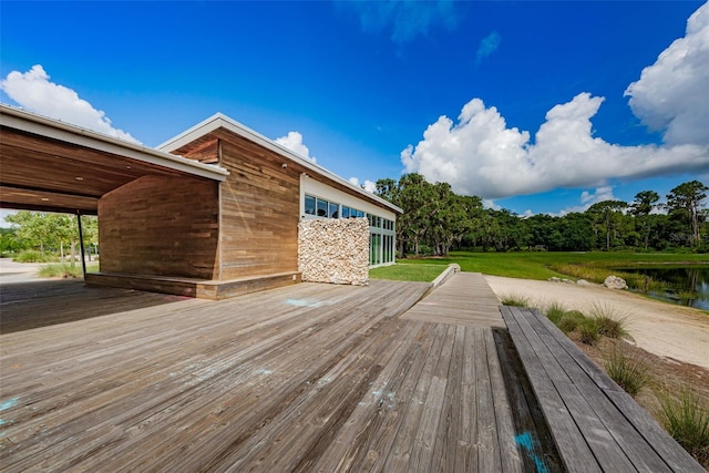 wooden terrace featuring a water view